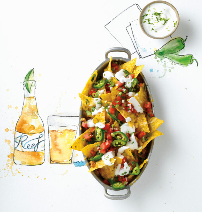Pan of nachos with a food related illustration