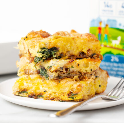 An egg casserole on a white plate and a fork